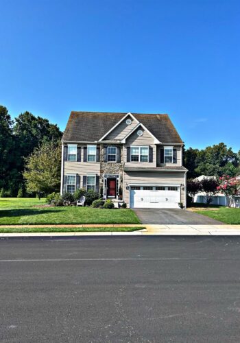 Before and after views of a cleared property in Sussex County, thanks to professional tree removal services.